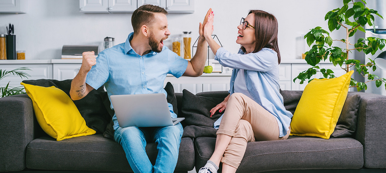 An excited couple on a couch